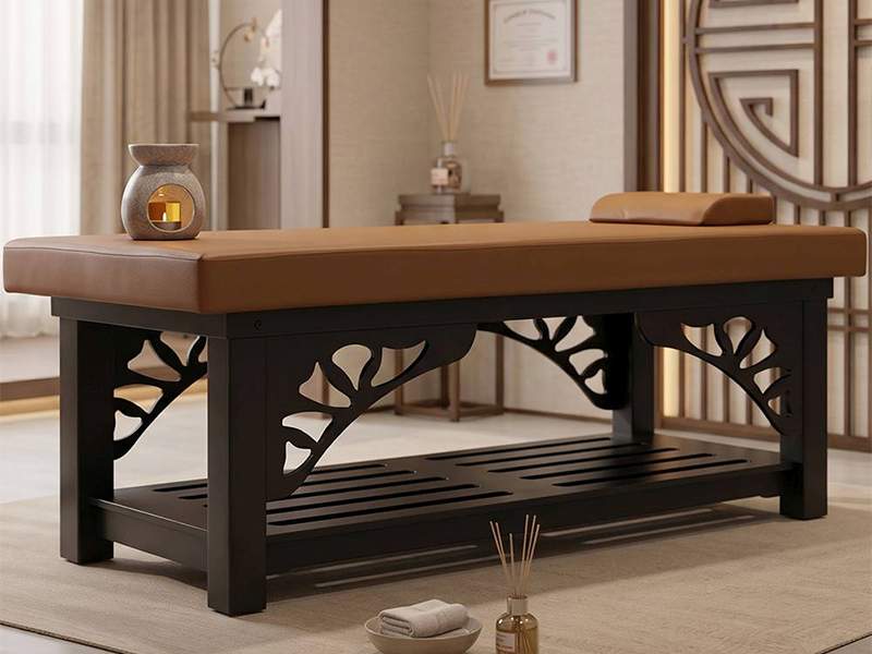 Kitama stationary Thai massage table in oak with wooden ornaments in a treatment room